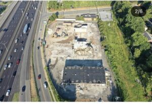 Aerial photograph showing multiple hotel buildings being demolished near Interstate 85.