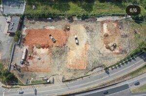 Excavator actively demolishing the Reagan Drive hotel during the City of Charlotte demolition project.