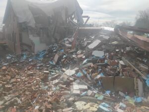 Close-up view of a commercial brick building being demolished at Dix Park in Raleigh, North Carolina. The image shows exposed structural steel, brick and concrete debris, insulation, and demolition materials as JCE, Inc. completes controlled structural demolition and material separation for site redevelopment.