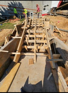 Concrete stair forms under construction before concrete placement.